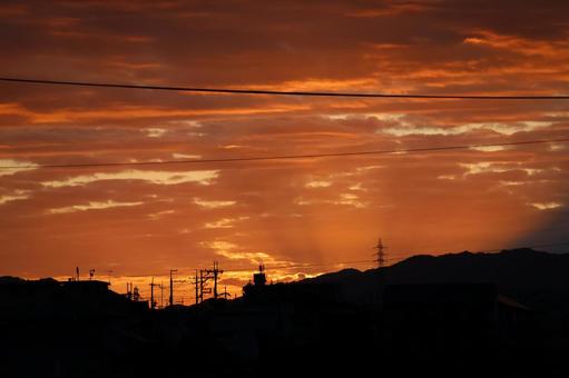 Orange evening sky and silhouette of mountain and city, JPG Orange evening sky and silhouette of mountain and city, JPG