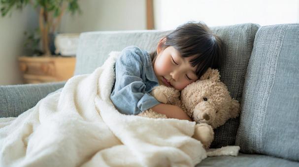 ソファーでお昼寝する女の子 ソファーでお昼寝する女の子の写真