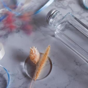 A simple arrangement of dried flowers and bottles, JPG