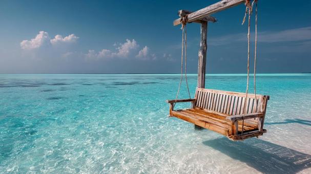 ミニマルなデザインの木製ブランコと青い海の写真