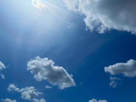 白い雲と陽光が広がる快晴の空 白い雲と陽光が広がる快晴の空の写真