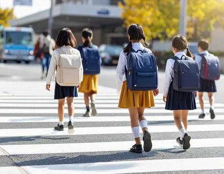 通学中の子供達の後ろ姿 通学中の子供達の後ろ姿の写真
