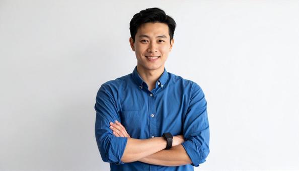青シャツで笑顔の男性が腕組むポートレート 青シャツで笑顔の男性が腕組むポートレートの写真