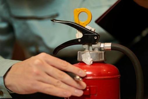 Asian man inspecting restaurant equipment, fire extinguisher, fire equipment, equipment inspection, JPG