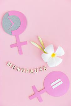 「MENOPAUSE」の文字と花と紙でできた雌記号 生理,月経,menopauseの写真素材