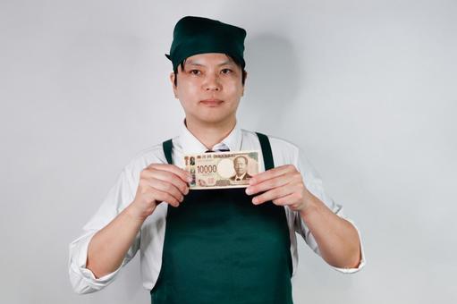 エプロン姿の男性と一万円札 エプロン姿の男性と一万円札 男性,エプロン,一万円札の写真素材