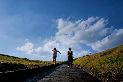 ＜素材＞山頂を散歩する家族の後ろ姿 家族,空,ウォーキングの写真素材