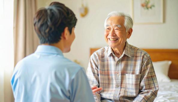 笑顔で話をする男性介護士と高齢男性 笑顔で話をする男性介護士と高齢男性の写真