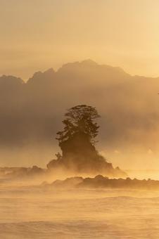 早朝｜気嵐に包まれる女岩_縦 富山,高岡,雨晴海岸の写真素材