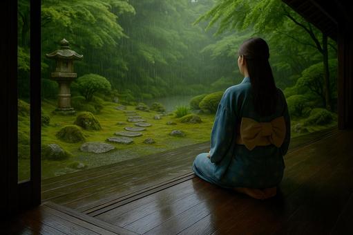雨の庭を眺める浴衣の女性 雨の庭を眺める浴衣の女性の写真