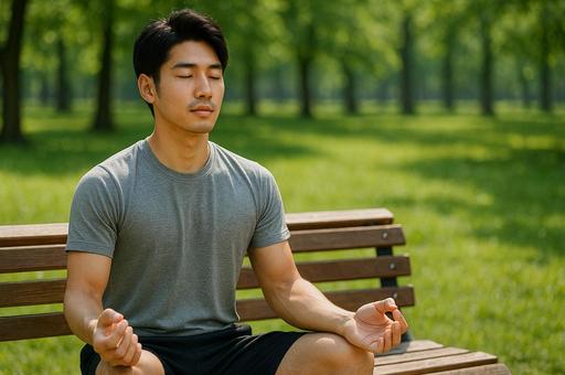 公園ベンチで瞑想する男性 公園ベンチで瞑想する男性の写真