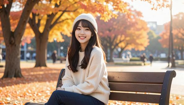 秋の公園のベンチの女性 秋の公園のベンチの女性の写真