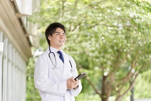 Doctor standing with a smile on a green background, un medico, un medico, un uomo, JPG