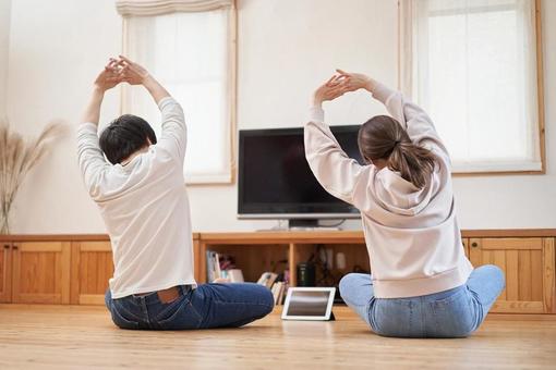 A couple stretching in the living room at home, stretch, living, home, JPG