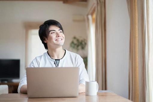 Asian man operating a computer in the living room, ein mann, laptop-computer, leben, JPG