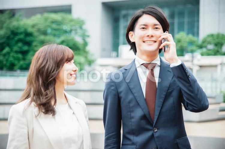 スマホを使うビジネスマンと女性（電話） ビジネス,話す,通話の写真素材