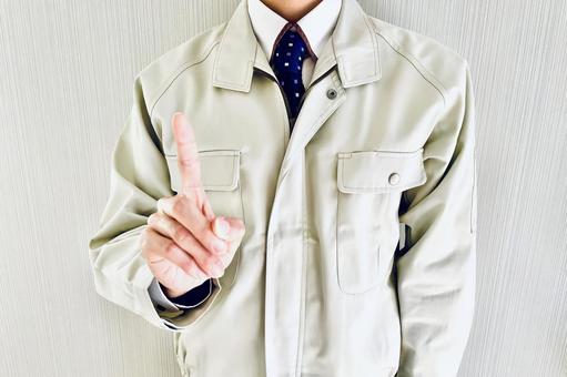 人差し指を立てる作業着姿の男性 ポイント,指す,チェックの写真素材