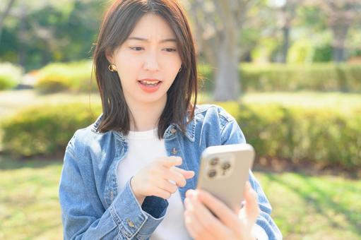 A woman getting angry at her smartphone, JPG A woman getting angry at her smartphone, JPG