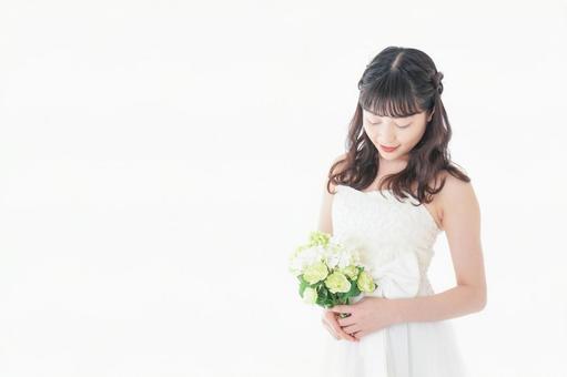 ブーケを持ち指差す花嫁の女性 ブーケを持ち指差す花嫁の女性 笑顔,注意点,女性の写真素材