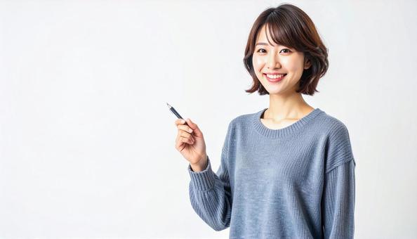 ペンで指差しする日本人女性 ペンで指差しする日本人女性の写真