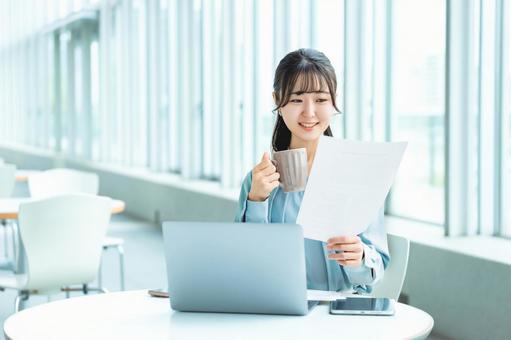 オフィスで仕事をするビジネスウーマン オフィスで仕事をするビジネスウーマン 女性,ノートパソコン,リビングの写真素材