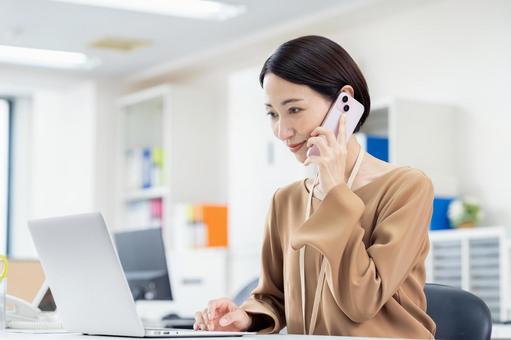 オフィスで電話するビジネスウーマン オフィスで電話するビジネスウーマン 電話,ビジネスウーマン,ビジネスの写真素材