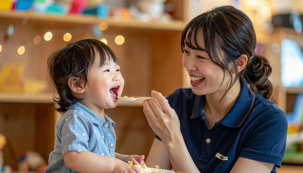 子どもにご飯をあげる保育士 子どもにご飯をあげる保育士の写真