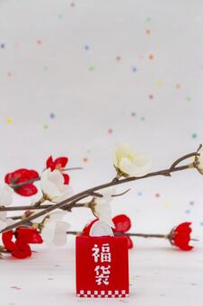 福袋と紅白梅（カラフルな和紙背景） 福袋,梅,花の写真素材