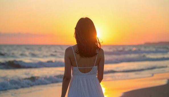 夕日を見る少女の写真