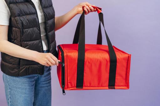 保温ピザバッグを持っている女性配達員 配達,デリバリー,配送の写真素材