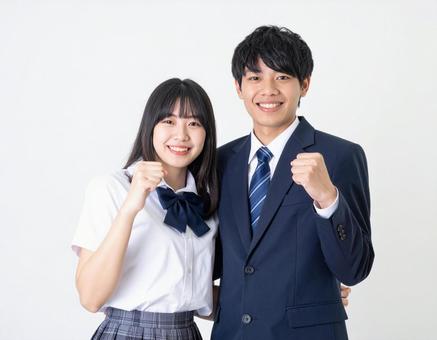 ガッツポーズする高校生男女 ガッツポーズする高校生男女の写真