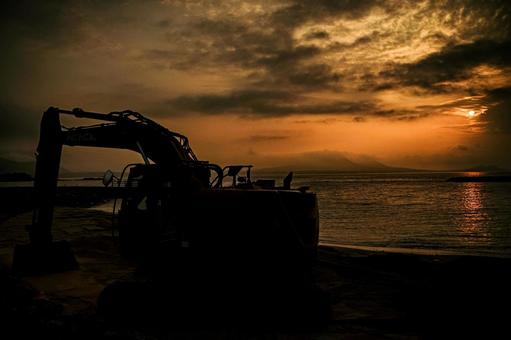 <Material> A shovel for leveling a beach at dawn, JPG <Material> A shovel for leveling a beach at dawn, JPG