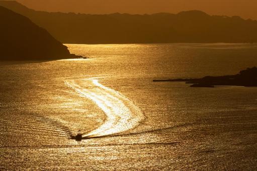黄金色に輝く夕暮れの海と船 海,夕日,風景の写真素材