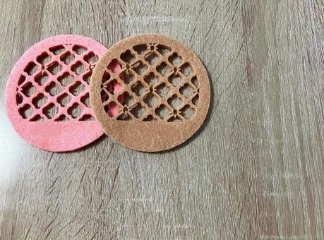 A pair of pink and brown round coasters, JPG
