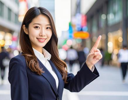 ポイントを指差す若い女性 ポイントを指差す若い女性の写真