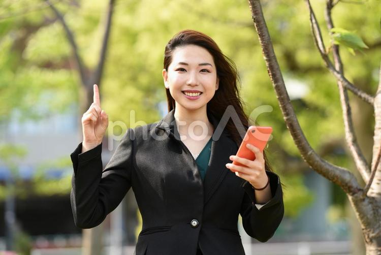 屋外でスマホを持つビジネスウーマン 女性,スマートフォン,スマホの写真素材