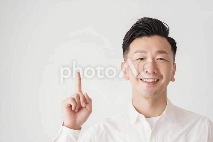 人差し指を立てるポーズをする男性  男性,ミドル,ナンバーワンの写真素材