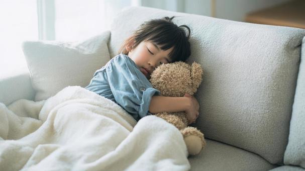 ソファーでお昼寝する女の子 ソファーでお昼寝する女の子の写真