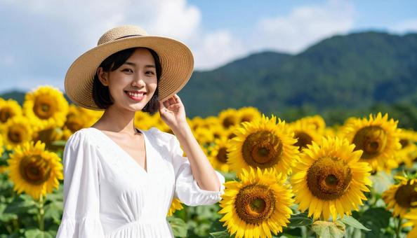 ひまわり畑と笑顔の白いワンピース姿の女性 ひまわり畑と笑顔の白いワンピース姿の女性の写真