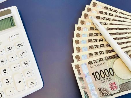 Money and a white calculator (managing finances/household finances), JPG