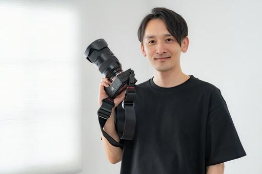 カメラマン 男性,大人,レンズの写真素材