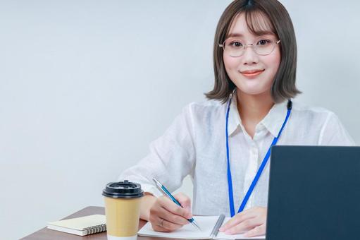 カメラ目線の女性スタッフ 女性,若い,眼鏡の写真素材