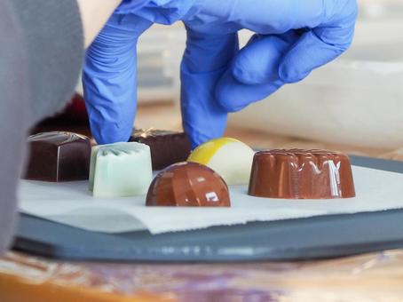 Hands arranging chocolates, JPG Hands arranging chocolates, JPG