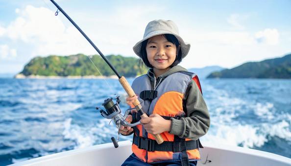 釣りを楽しむライフジャケットの女の子  釣りを楽しむライフジャケットの女の子の写真