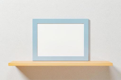 White wall. Blue horizontal A4 and A3 size picture frames. White wall. Blue horizontal A4 and A3 size picture frames.