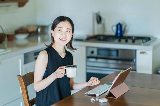 A woman operating a tablet PC in the dining room, interior, pw, la cocina, JPG