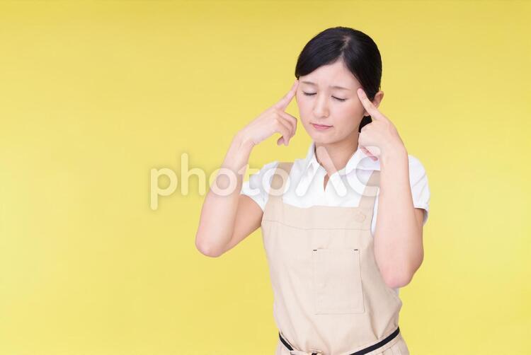 頭痛を訴える女性 女性,女,主婦の写真素材