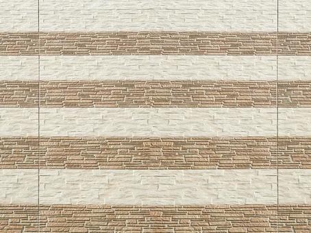 Beige stone-patterned siding on the exterior of a house, JPG
