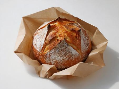クラフト紙と焼きたてのカンパーニュ クラフト紙と焼きたてのカンパーニュの写真