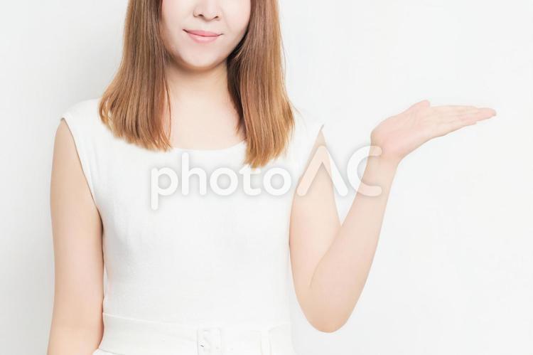 案内のジェスチャーをする若い女性 女性,案内,こちらの写真素材
